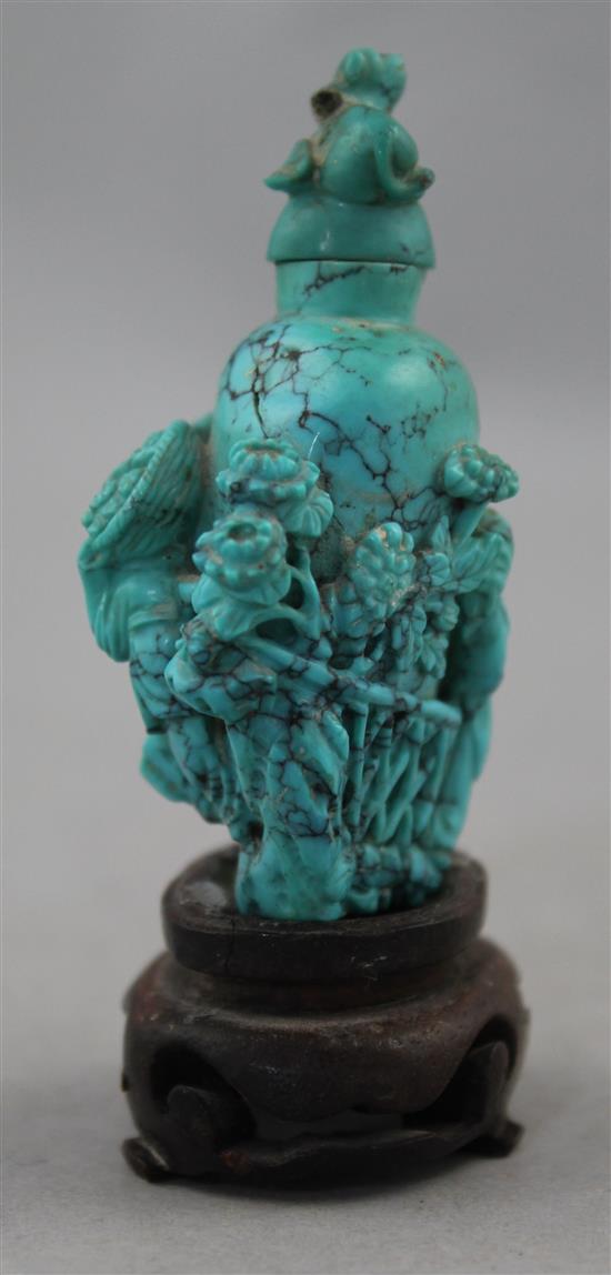 A Chinese turquoise matrix snuff bottle, late 19th / early 20th century, 6.5cm., wood stand, repair to cover